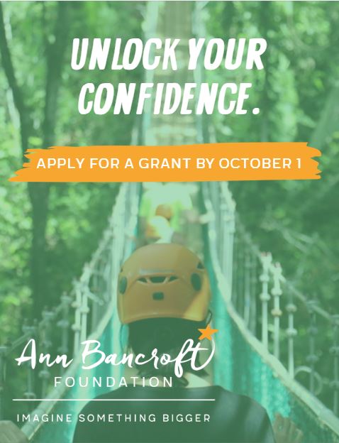 Photograph of a girl crossing a rope bridge in a forest. Text reads "Unlock your confidence. Apply for a grant by October 1. Ann Bancroft Foundation: Imagine Something Bigger."